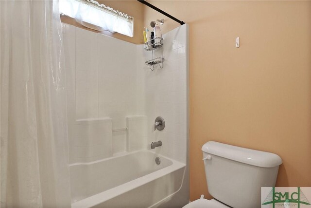 bathroom featuring shower / bathtub combination with curtain and toilet