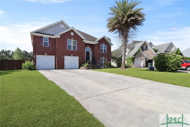 bi-level home with driveway, a garage, brick siding, fence, and a front lawn