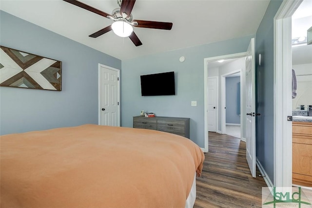 bedroom with dark wood-style flooring, baseboards, and a ceiling fan