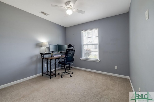 office space with baseboards, carpet flooring, and a ceiling fan