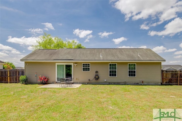 back of property with a patio area, fence, and a yard