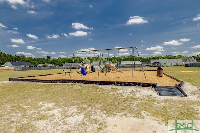 community jungle gym featuring a lawn and fence