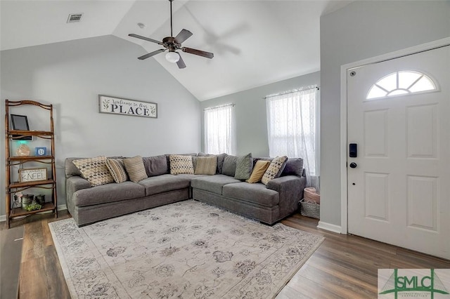 living area with ceiling fan, lofted ceiling, dark wood-style floors, and visible vents