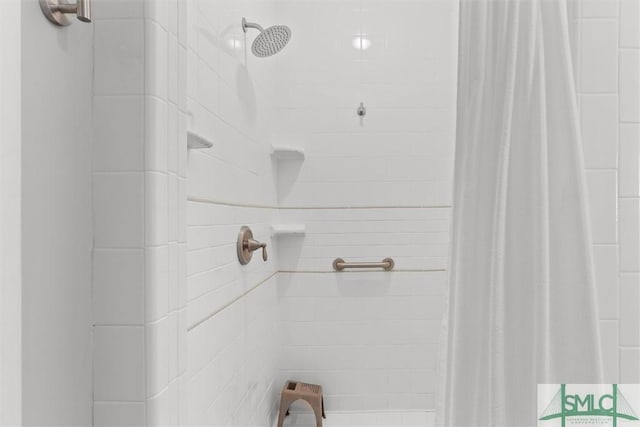 full bath with a tile shower