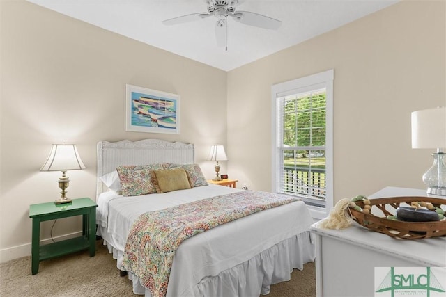 carpeted bedroom featuring baseboards and a ceiling fan
