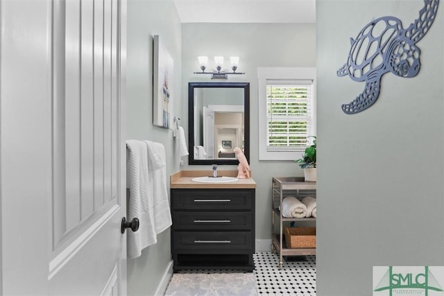 bathroom featuring baseboards, tile patterned floors, and vanity