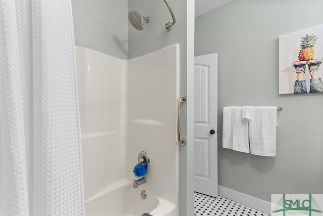 full bathroom with baseboards and shower / tub combo with curtain