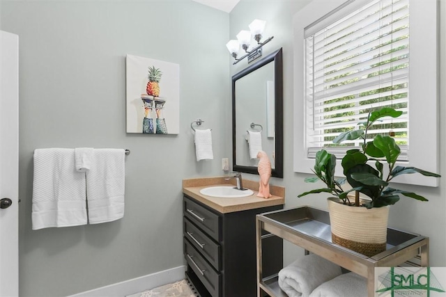 bathroom featuring baseboards and vanity