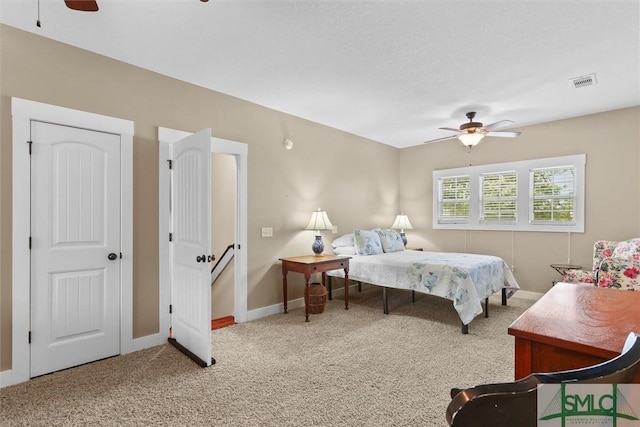 bedroom with ceiling fan, carpet floors, baseboards, and visible vents