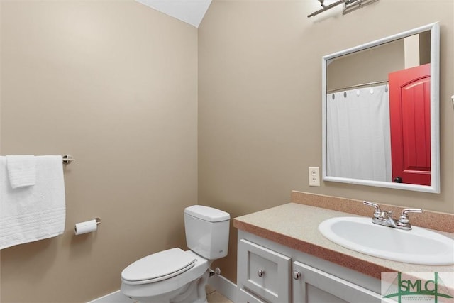 full bathroom featuring a shower with curtain, vanity, baseboards, tile patterned floors, and toilet