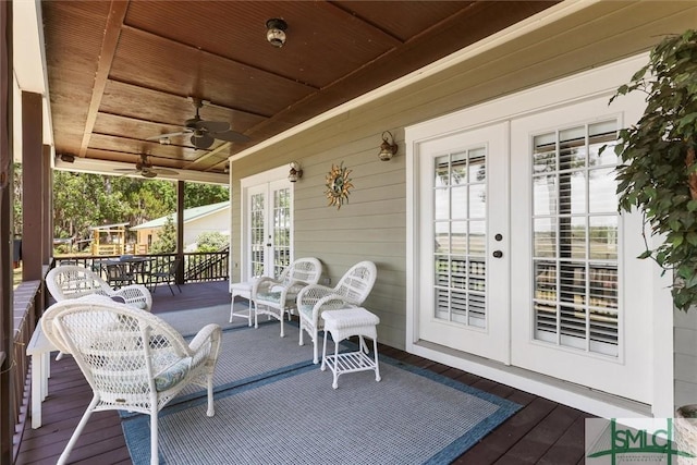 view of patio featuring french doors, a ceiling fan, and a deck