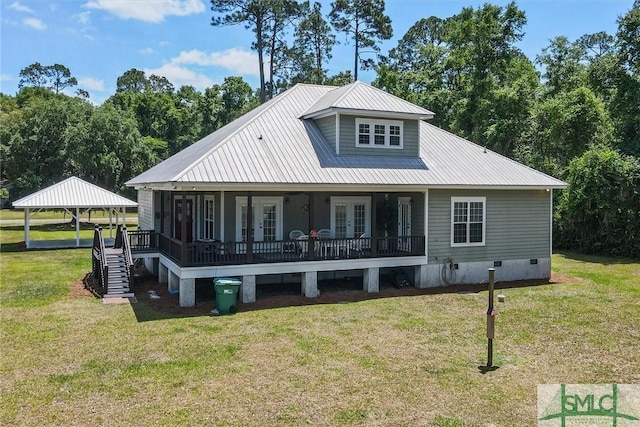 rear view of house with a yard, french doors, crawl space, and metal roof