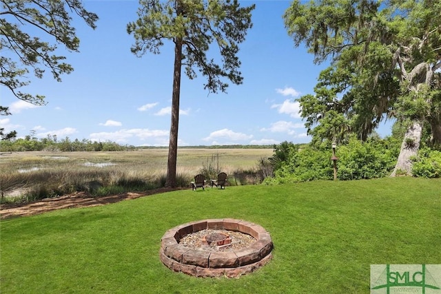 view of yard with a fire pit and a rural view