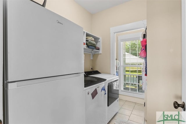 laundry area with separate washer and dryer, light tile patterned flooring, and laundry area
