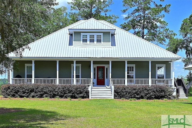 farmhouse inspired home with a porch, metal roof, and a front lawn