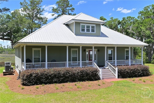 1261 Otter Slide Loop NE, Townsend, GA 31331 - country-style home with covered porch, metal roof, cooling unit, and a front lawn