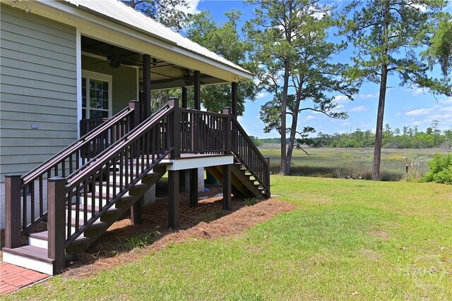 1261 Otter Slide Loop NE, Townsend, GA 31331 - view of grassy yard with stairs and ceiling fan