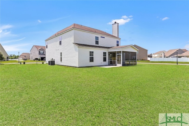 98 Westbourne Way, Savannah, GA 31407 - back of property with fence, cooling unit, a chimney, a sunroom, and a lawn
