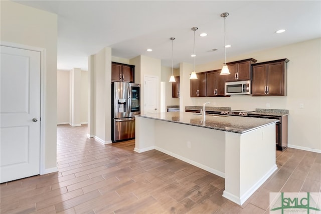 98 Westbourne Way, Savannah, GA 31407 - kitchen with dark brown cabinets, a sink, light wood-style floors, dark stone countertops, and stainless steel appliances