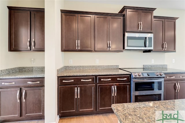 98 Westbourne Way, Savannah, GA 31407 - kitchen featuring dark brown cabinets, light stone countertops, appliances with stainless steel finishes, and light wood-style flooring