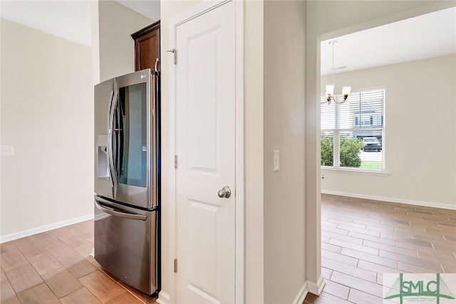 98 Westbourne Way, Savannah, GA 31407 - kitchen featuring wood tiled floor, baseboards, stainless steel refrigerator with ice dispenser, and a notable chandelier