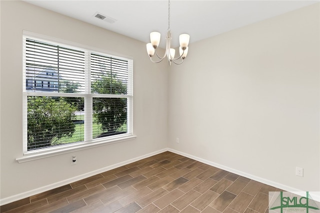 98 Westbourne Way, Savannah, GA 31407 - spare room with visible vents, baseboards, dark wood-type flooring, and an inviting chandelier