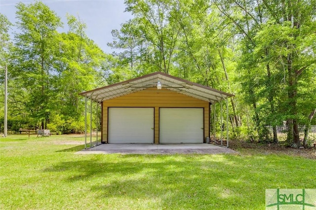 detached garage featuring fence