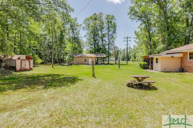 view of yard with an outdoor structure and a storage unit