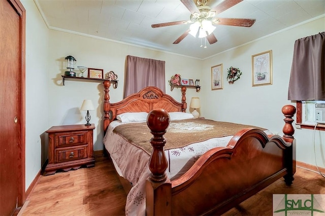 bedroom with ceiling fan, crown molding, wood finished floors, baseboards, and cooling unit