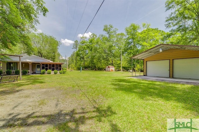 view of yard featuring a garage and an outbuilding