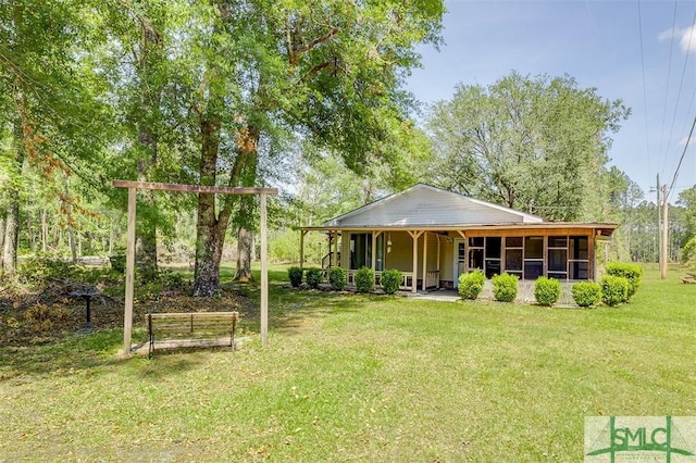rear view of property featuring a lawn