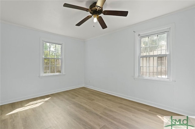 unfurnished room with crown molding, a ceiling fan, baseboards, and wood finished floors