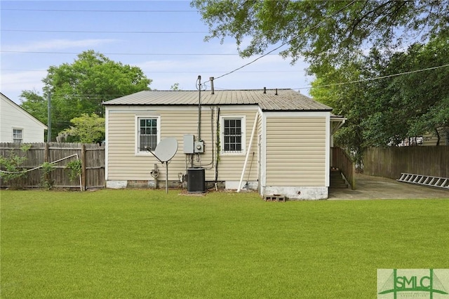 back of house featuring central AC, fence, a yard, and crawl space