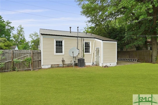 back of property with fence, central AC unit, a lawn, and crawl space