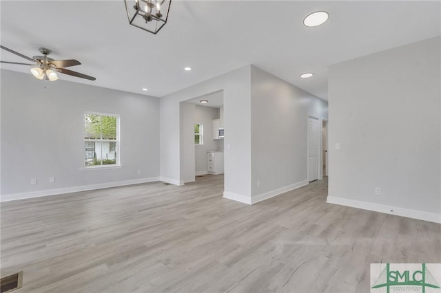 unfurnished living room with light wood finished floors, a ceiling fan, baseboards, recessed lighting, and visible vents