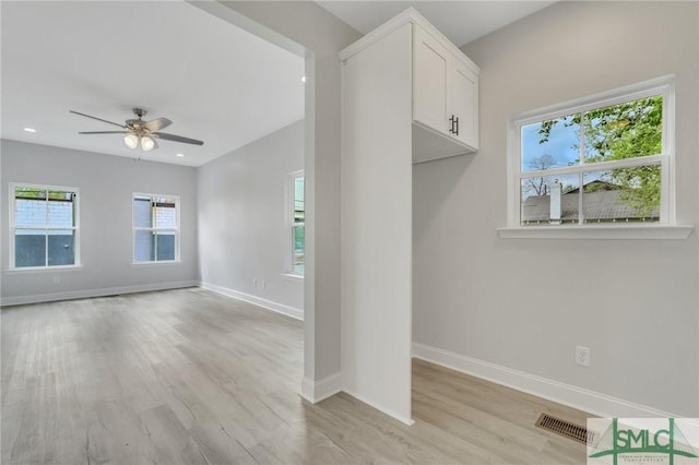 interior space with ceiling fan, visible vents, baseboards, light wood-style floors, and recessed lighting