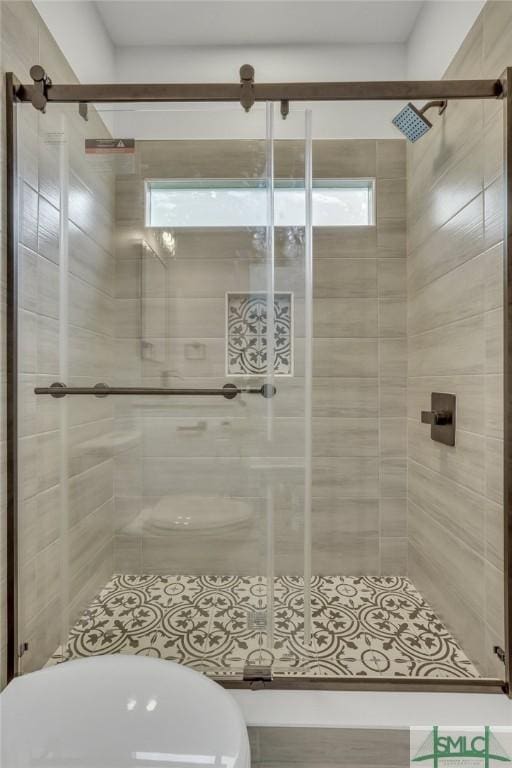 full bath with toilet and a shower stall