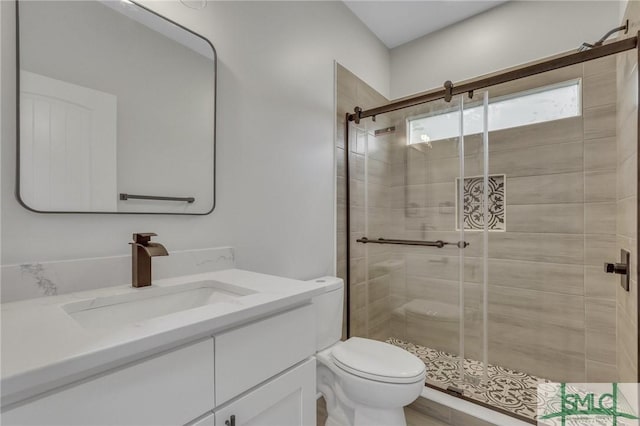 full bathroom with vanity, a stall shower, and toilet