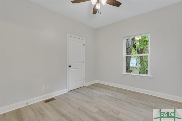 unfurnished room with visible vents, baseboards, ceiling fan, and light wood-type flooring