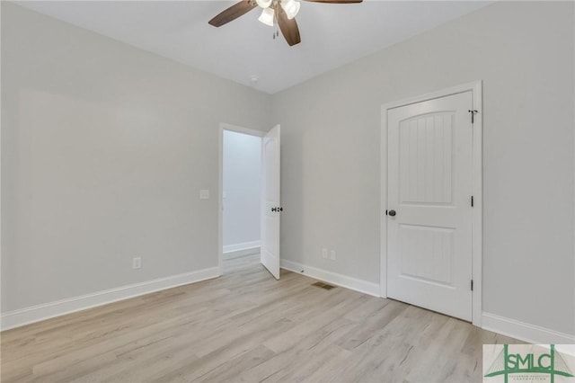 unfurnished bedroom featuring light wood-style floors, baseboards, a ceiling fan, and visible vents