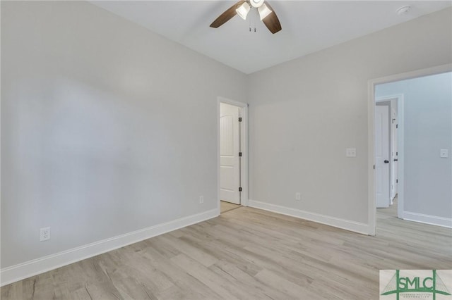 empty room featuring baseboards, a ceiling fan, and light wood finished floors