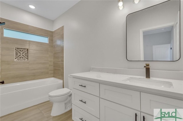 bathroom with vanity, toilet,  shower combination, and wood finished floors