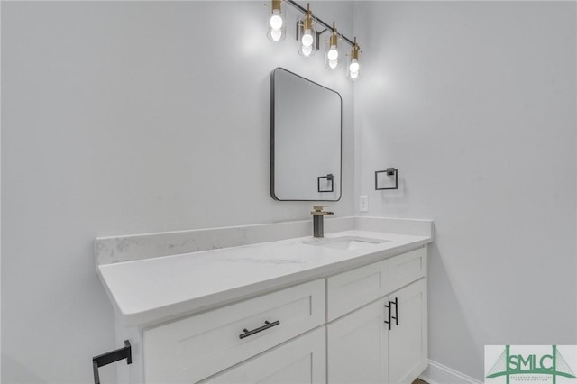 bathroom with baseboards and vanity