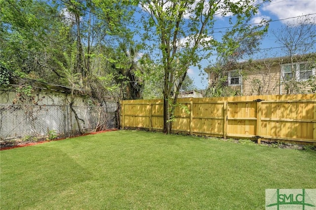 view of yard with a fenced backyard