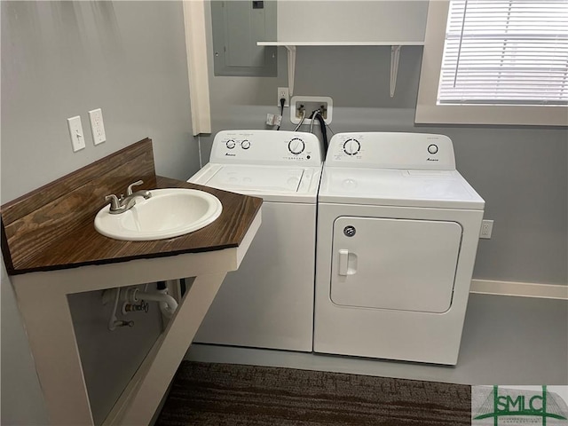 laundry area featuring independent washer and dryer, a sink, and electric panel
