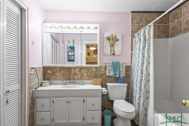 219 N College St, Pembroke, GA 31321 - full bath with tile walls, curtained shower, vanity, a closet, and toilet