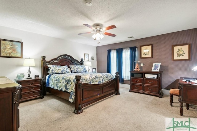 219 N College St, Pembroke, GA 31321 - bedroom featuring visible vents, a textured ceiling, ceiling fan, and light carpet