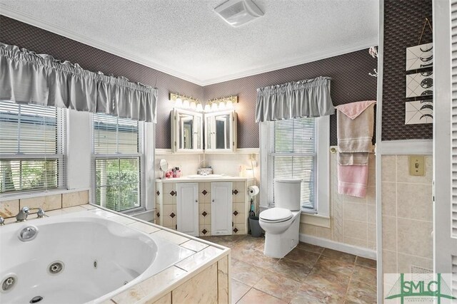 219 N College St, Pembroke, GA 31321 - bathroom featuring a textured ceiling, vanity, a whirlpool tub, toilet, and ornamental molding