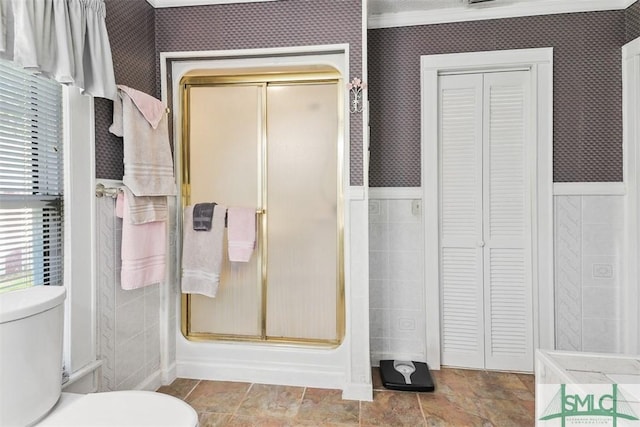 219 N College St, Pembroke, GA 31321 - full bathroom featuring a stall shower, wallpapered walls, a closet, and toilet