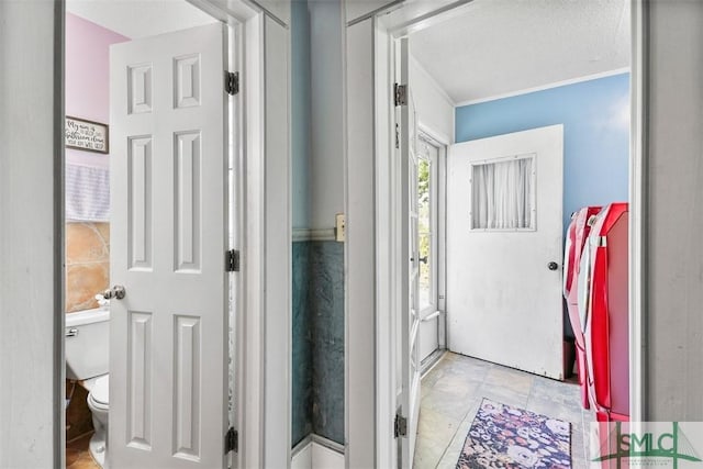 219 N College St, Pembroke, GA 31321 - bathroom featuring ornamental molding, stone finish floor, and toilet